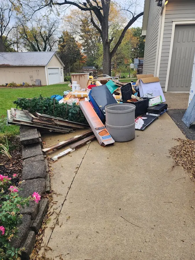 Dumpster being loaded with debris for 12 Yard Dumpster Rental in Broadalbin